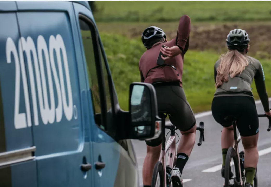 2moso van following two cyclists on the road